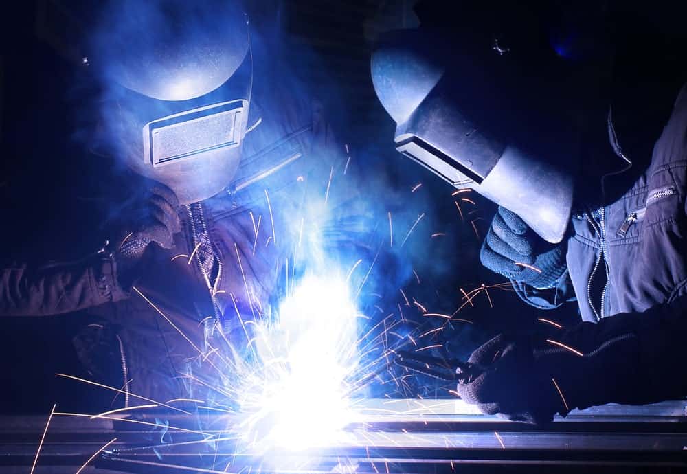 2 workers doing custom metal fabrication for Employment page